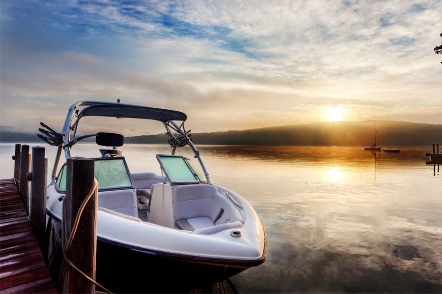 Watercraft Insurance - View of a Boat Parked at the Dock on a Calm Lake at Sunset